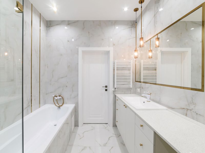 bathroom interior design with light tiles and a mirror