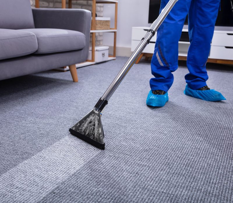 Male Janitor Cleaning Carpet